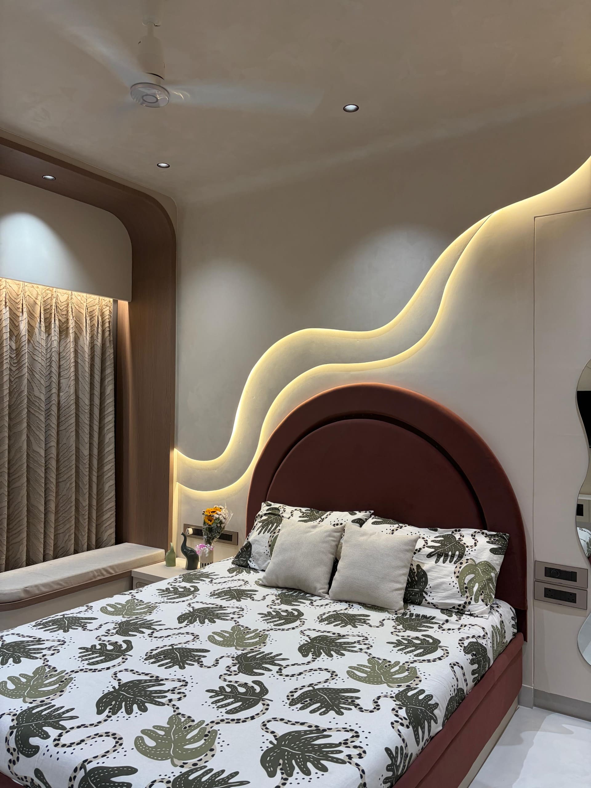Master bedroom with arched velvet headboard